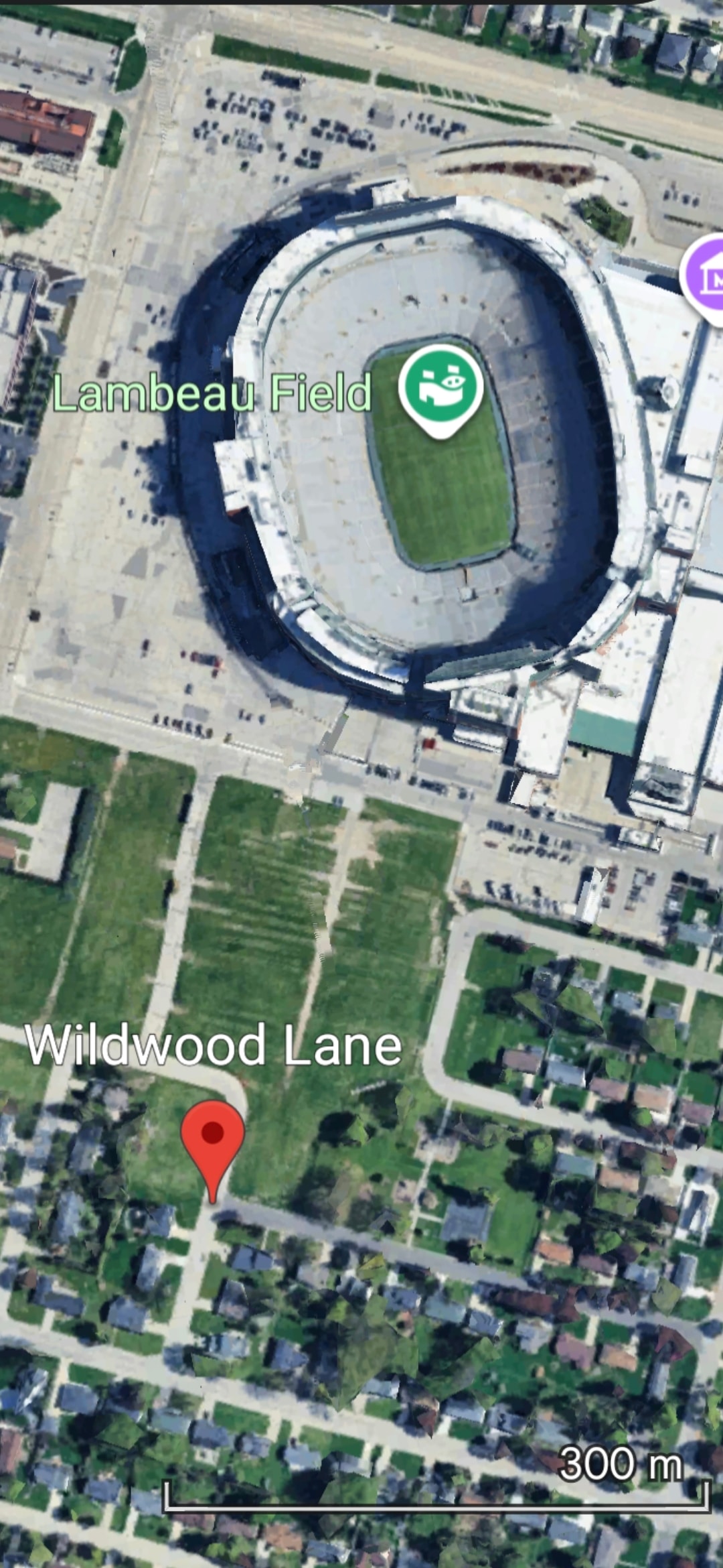 Google Maps aerial view showing 2077 Wildwood Ln parking location steps from Lambeau Field